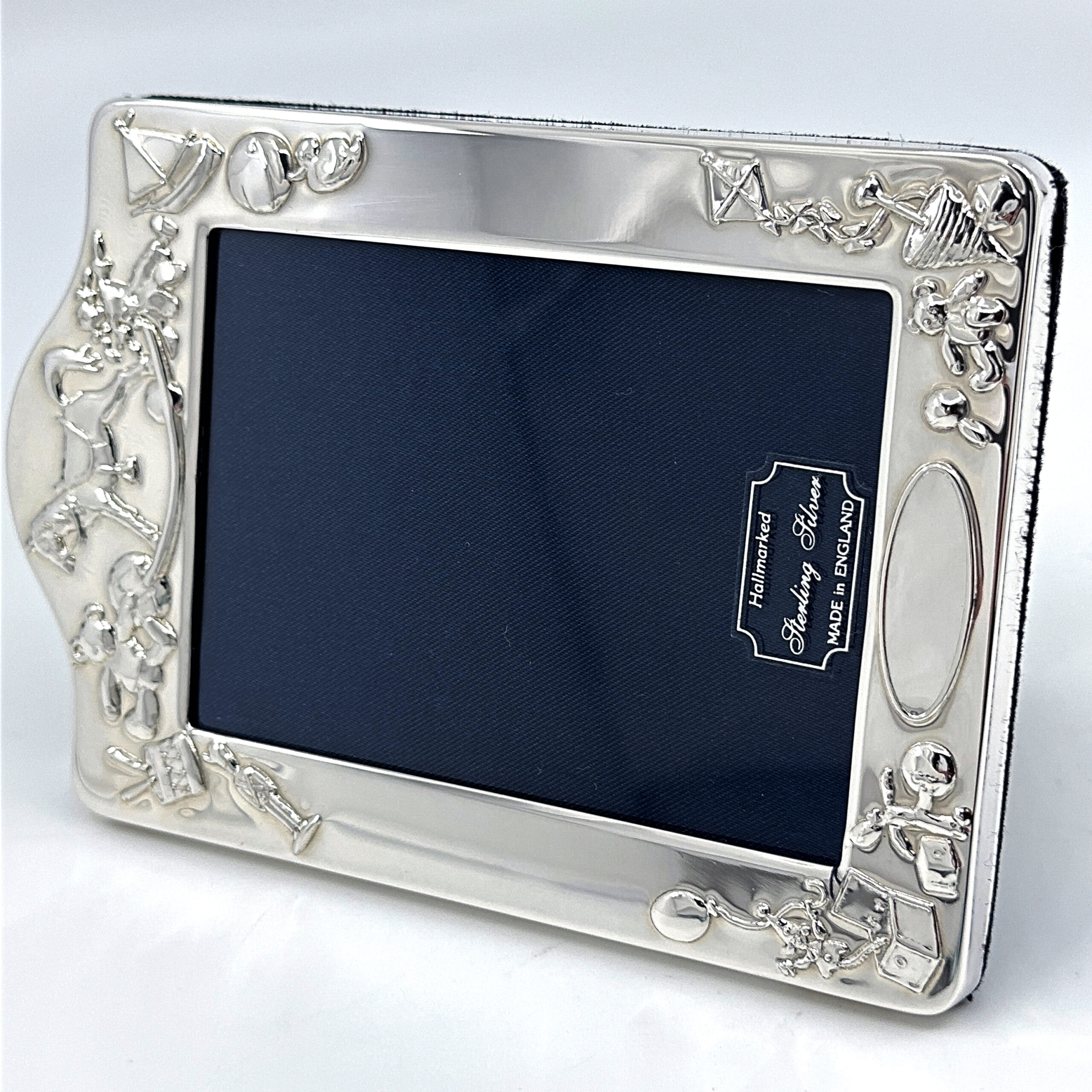 FR534 (4) Baby Photo Frame With Toy Motif Border And Blue Velvet Back Finished In 925 English Hallmarked Sterling Silver